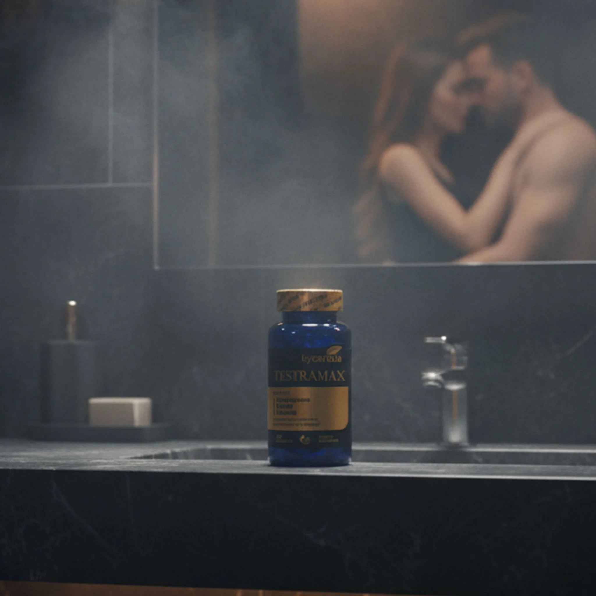 TESTRAMAX bottle on a bathroom counter with a couple blurred in the background, representing enhanced male vitality, libido, and intimate confidence.