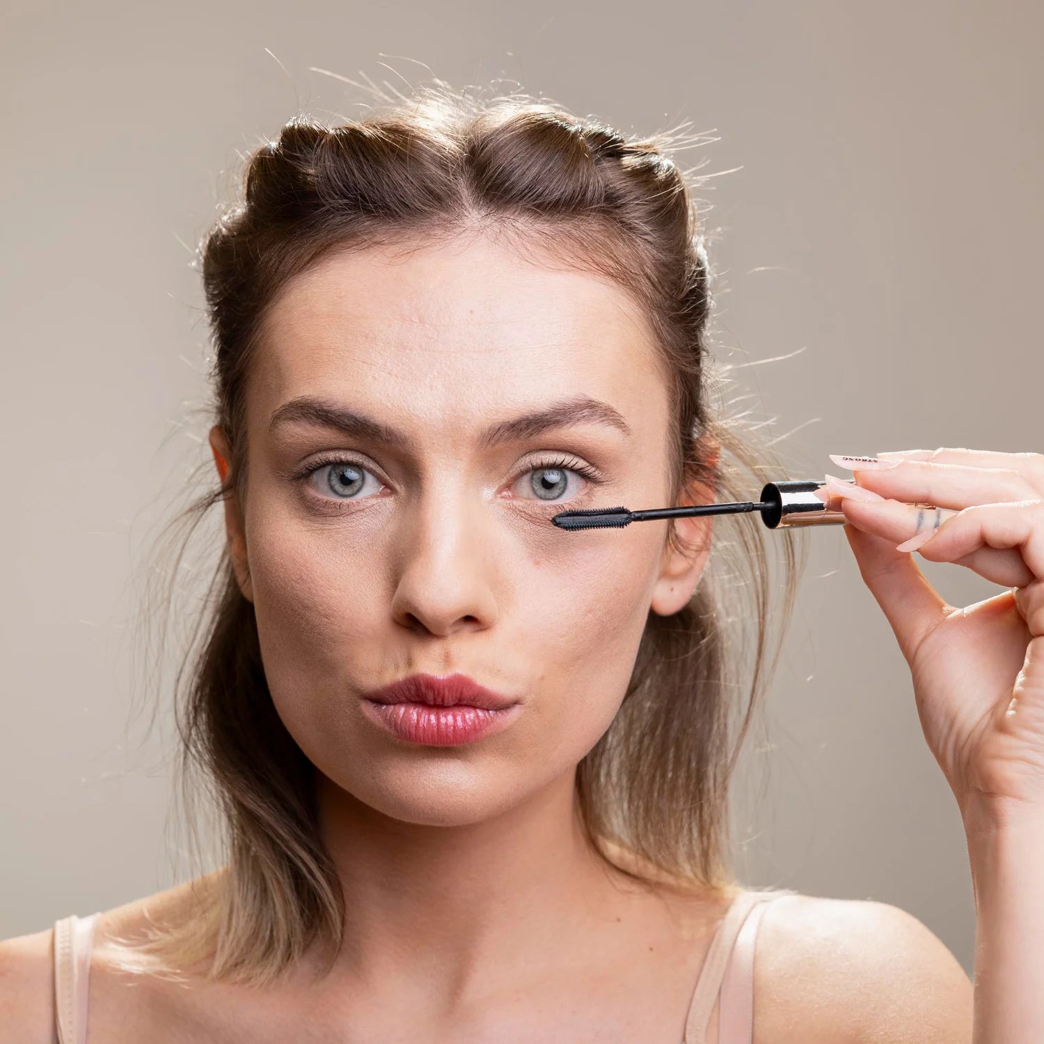 Morning skincare scene applying lash and brow serum for a fresh natural look.