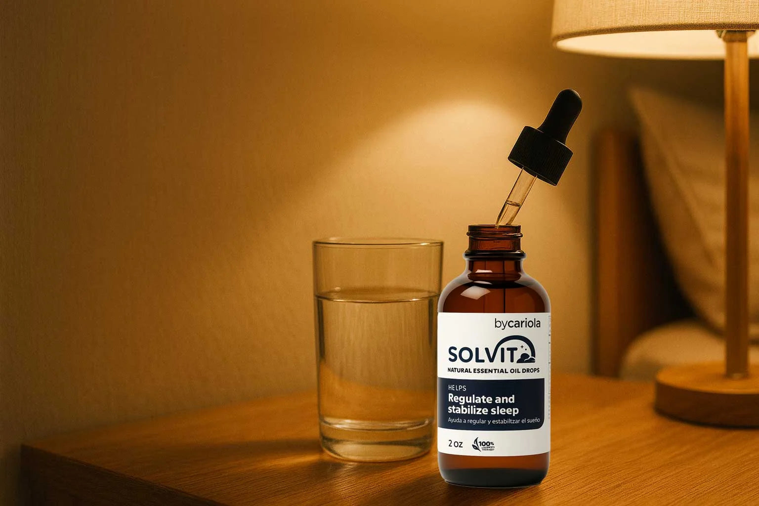 Glass of water on a bedside table with warm light, Solvit Sleep Drops dropper ready to use.
